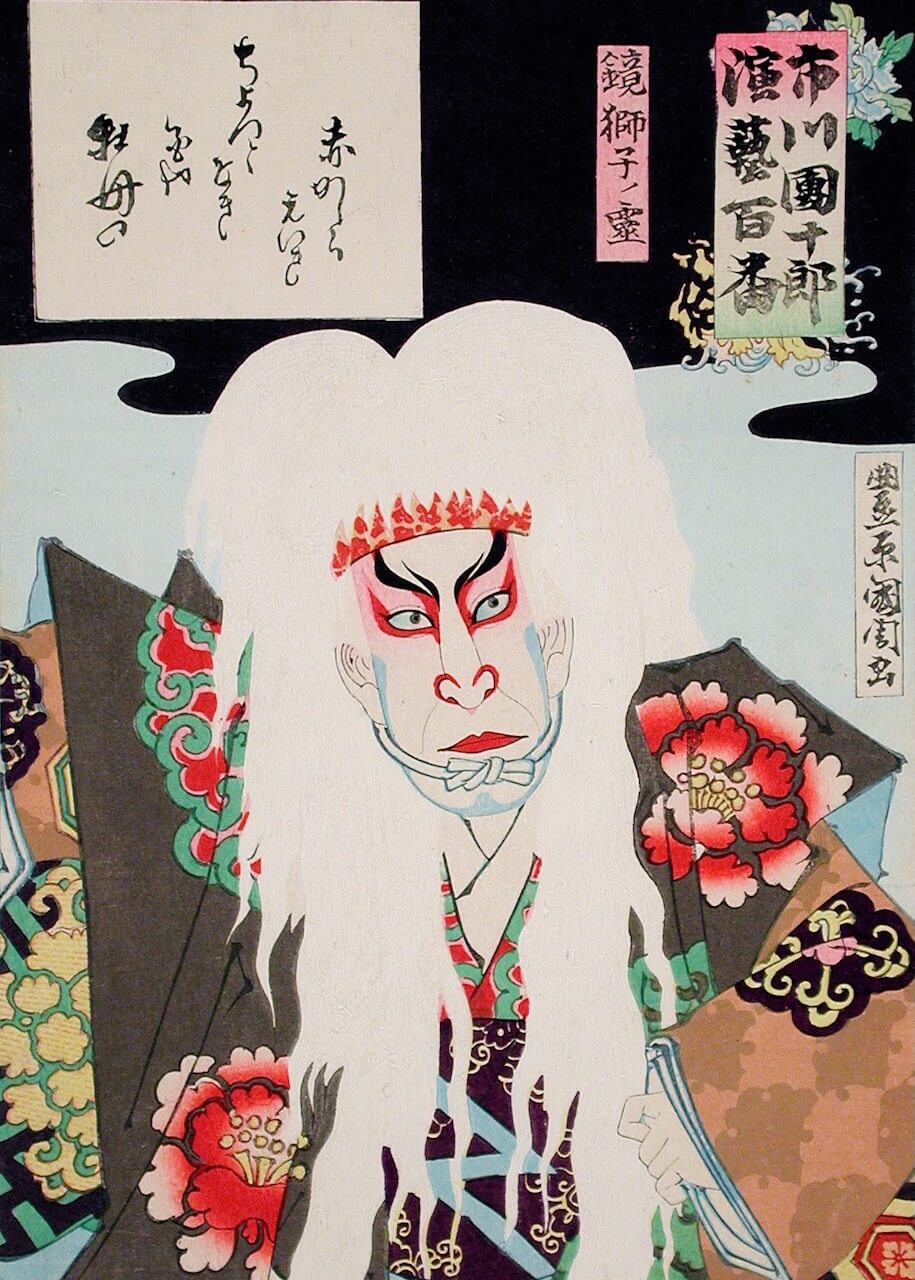 Plakaten "Spirit of a Lion Mask" fra Posters viser et traditionelt japansk træsnit af en kabuki-skuespiller i dramatisk kostume og makeup, vildt hvidt hår som en løvemaske, udsmykkede blomstrede klæder og dristige røde ansigtslinjer på en stiliseret baggrund.
